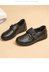 Detailed side view of black cowhide leather mom shoes with velcro strap and soft sole design