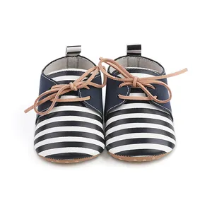 Detailed view of navy white striped baby walking shoes featuring soft tan laces