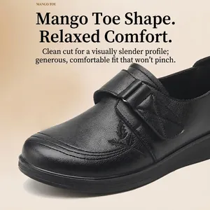 Comfortable black genuine leather women's flat shoes featuring a hook-and-loop strap closure