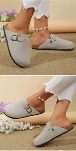 Detail of light grey suede clogs with adjustable buckle and cork-textured footbed