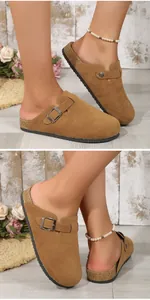 Detailed view of brown suede clogs with cork-like soles and adjustable metal buckle strap.