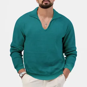 Close-up of men's waffle knit long sleeve polo shirt in teal with a V-neck collar