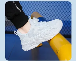 Close-up of white breathable mesh children's sneakers featuring a rotary lace system
