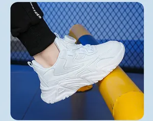 Close-up detail of white breathable kids sports shoes with modern rotary dial lacing system