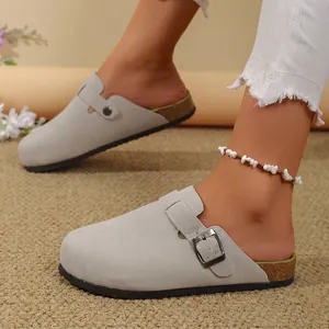 Elegant grey suede women's clogs with an adjustable buckle strap and cork sole