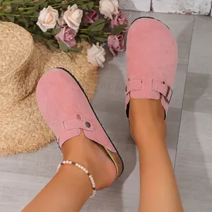 Casual pink suede closed-toe Boston clogs with adjustable buckle strap on cork sole