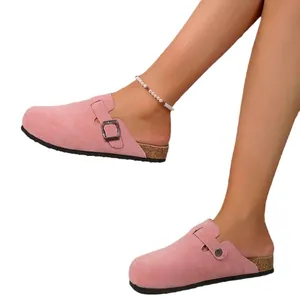 Pink suede closed-toe clogs with adjustable buckle and cork-style flat sole for women