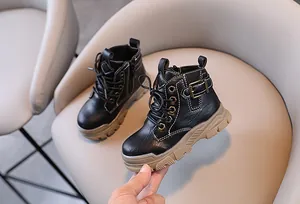 Detailed view of black children's Martin boots with side zipper and durable soles