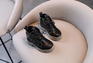 Detail of classic black children's Martin boots featuring side zipper and durable soles