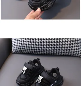 Detail of black children's dad sneakers with cute bear decoration and leather finish.