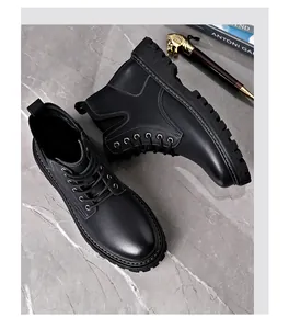 Detailed top-down view of black leather Martin boots on a marble surface with a decorative pen