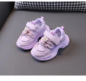Detail view of purple children's chunky dad sneakers with cute bear ornaments on laces
