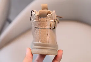 Close-up back view of children's tan leather Martin boots with buckle and zipper