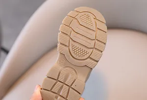 Close-up view of the anti-slip textured sole of kids Martin boots in tan color