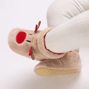 Detailed macro view of plush baby winter boots featuring a cute reindeer design