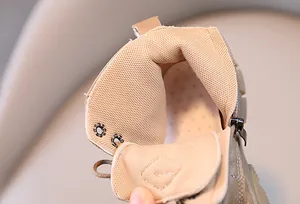 Detailed close-up of breathable mesh lining and side zipper on children's boots