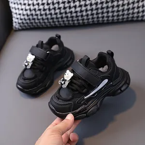 Black leather children's chunky sneakers with cute bear decoration for boys and girls.