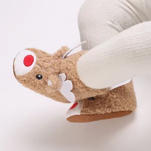 Macro detail of soft Sherpa fleece baby booties with cute animal face design