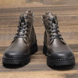 Detailed front view of brown genuine leather men's Martin boots with zippers on wood
