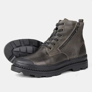 Close-up of premium dark gray leather men's work boots with side zipper and lace-up detail