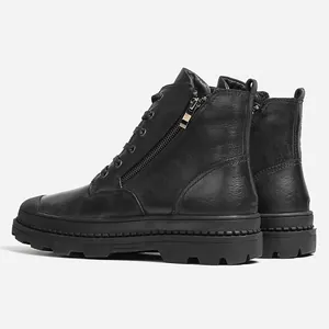 Detailed view of men's genuine black leather combat boots with side zipper and lug sole