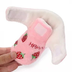 Close-up of pink baby bootie with strawberry embroidery and soft white faux fur lining