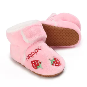 Detail view of soft pink baby boots with strawberry embroidery and fleece lining