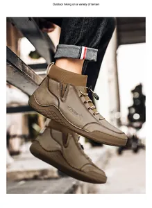 Close-up view of men's brown sock cuff work boots worn during an outdoor hiking session