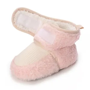Detail view of pink plush baby winter bootie with velcro strap and soft fleece lining
