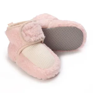 Detail view of pink fuzzy plush baby winter boots featuring anti-slip soles and velcro straps.