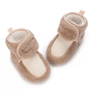 Close-up of soft plush baby winter boots with velcro strap and fleece lining