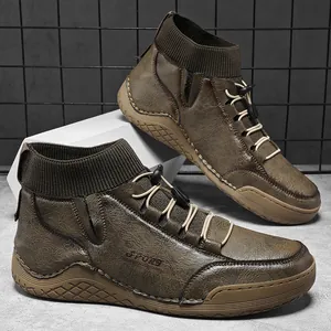 Detailed view of brown mens Martin boots with elasticated sock cuffs and rugged soles.