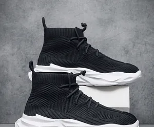 Detail view of black breathable high-top sock sneakers with chunky white soles.