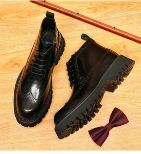 Detailed view of black shiny leather men's brogue boots featuring intricate carvings and thick soles