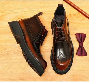 Detailed top view of classic brown leather brogue boots with intricate wingtip patterns