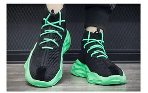 Detail of breathable high-top sock sneakers featuring black mesh and neon green thick soles.