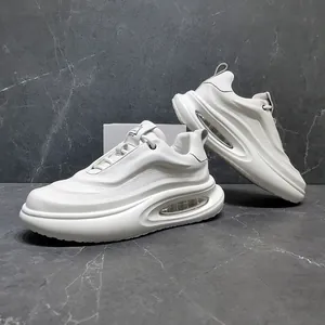Detailed side view of white leather chunky sneakers featuring a visible air cushion sole
