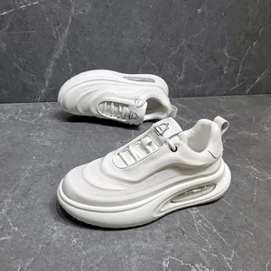 Detailed side view of white leather chunky sneakers with visible air cushion sole.