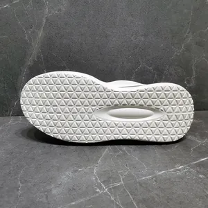 Macro view of white sneaker outsole featuring durable anti-slip triangular tread