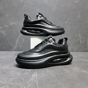 Close-up of black leather men's dad sneakers with breathable holes and air cushion platform sole