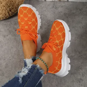 Vibrant orange knit platform sneakers with stylish pattern and white chunky soles