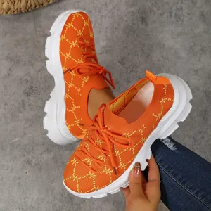 Detail of orange breathable knit platform sneakers for women with white thick sole
