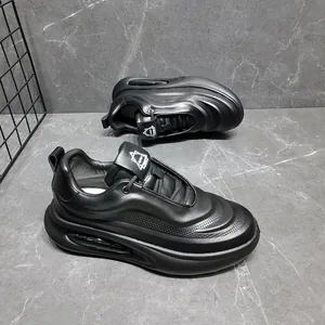 Close-up of black genuine leather men's dad shoes with chunky soles and perforated details.