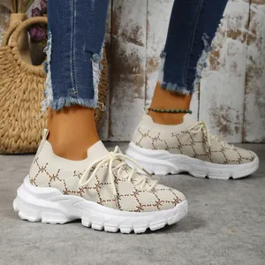 Close-up side view of women's beige knit platform sneakers featuring a chic geometric pattern