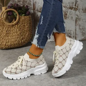 Detail of breathable women's knit platform sneakers with casual monogram pattern