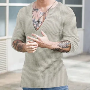 Detailed view of men's beige slim fit ribbed knit sweater featuring a deep V-neck design