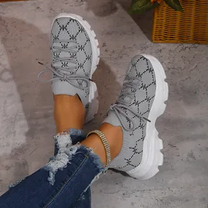 Close-up detail of women's gray knitted platform sneakers with breathable mesh upper