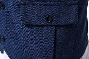 Dettaglio macro del tessuto tweed blu a spina di pesce su un gilet da uomo vintage