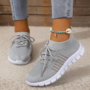 Side view detail of grey breathable fly-knit mesh sneakers for women with laces