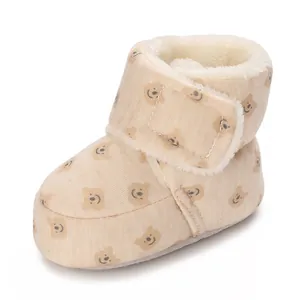 Detailed side view of warm fleece-lined baby winter boots with cute bear pattern design